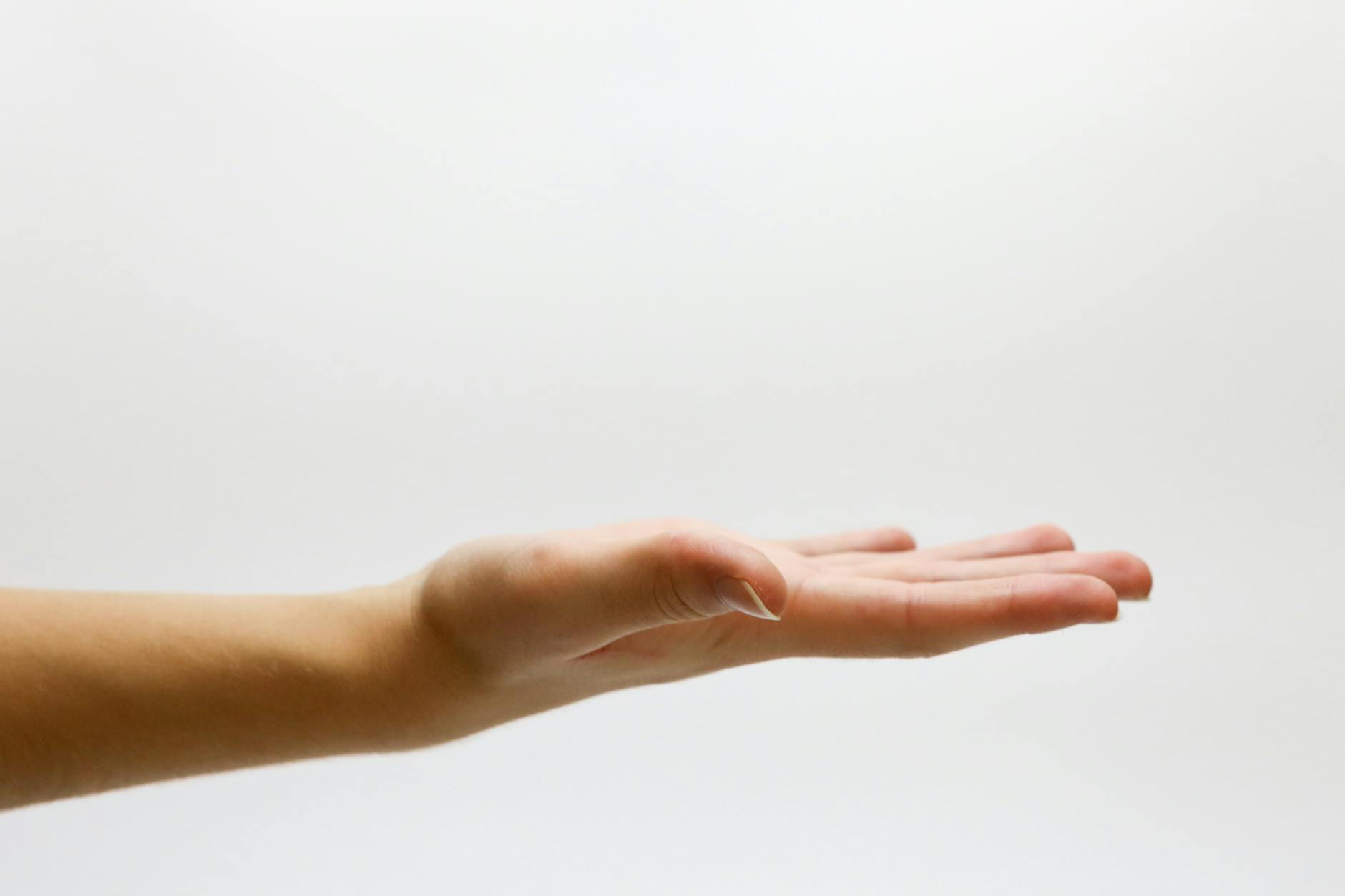 Open hand with palm facing up against a plain white background