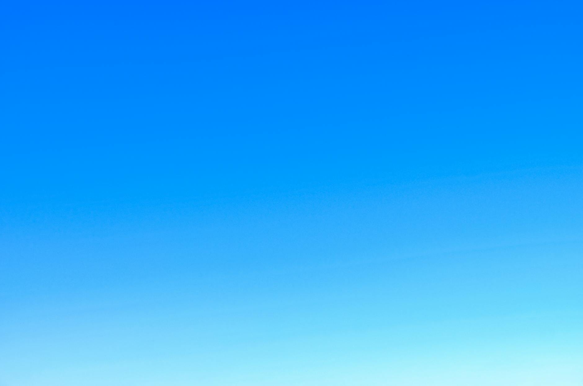 Clear blue sky with a soft gradient from light to deep blue.